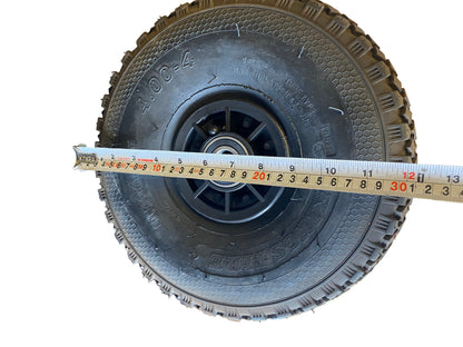 Tyre with a measuring tape showing its width.